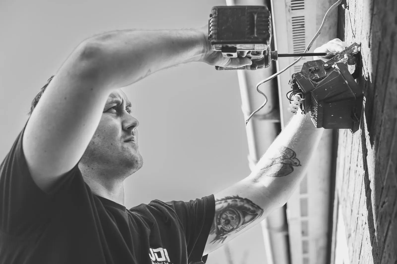 Close-up of a JDH electrician working on an installation
