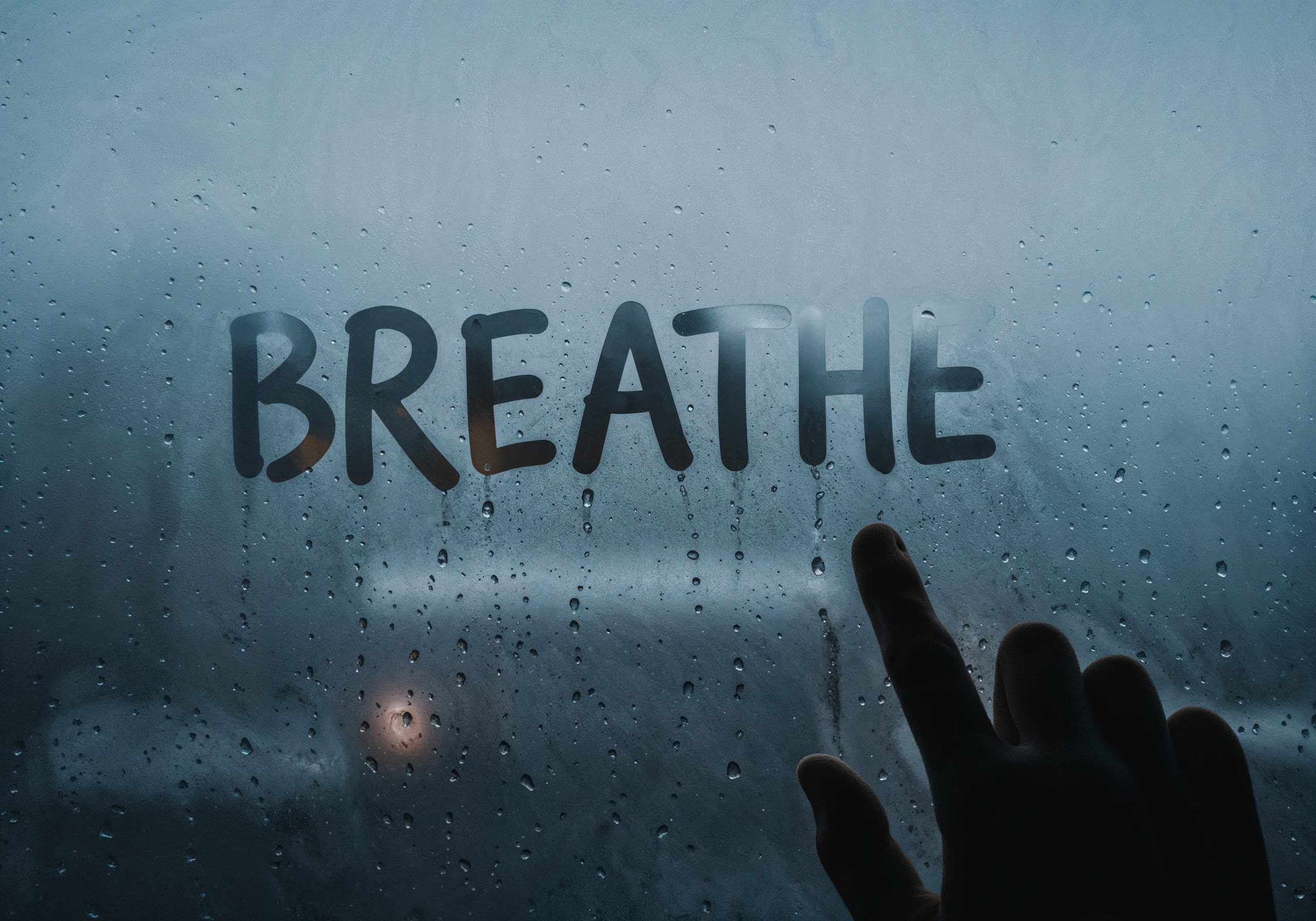 Breathe written on steamy glass
